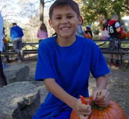 Boy carving Pumpkin