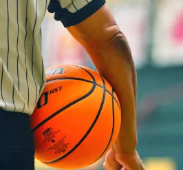 Image of a basketball official holding a basketball