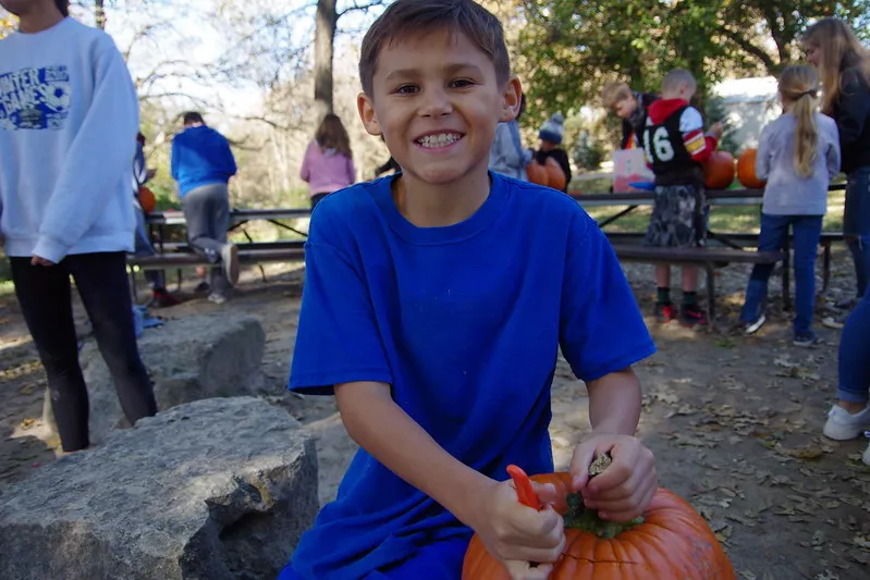Boy carving Pumpkin