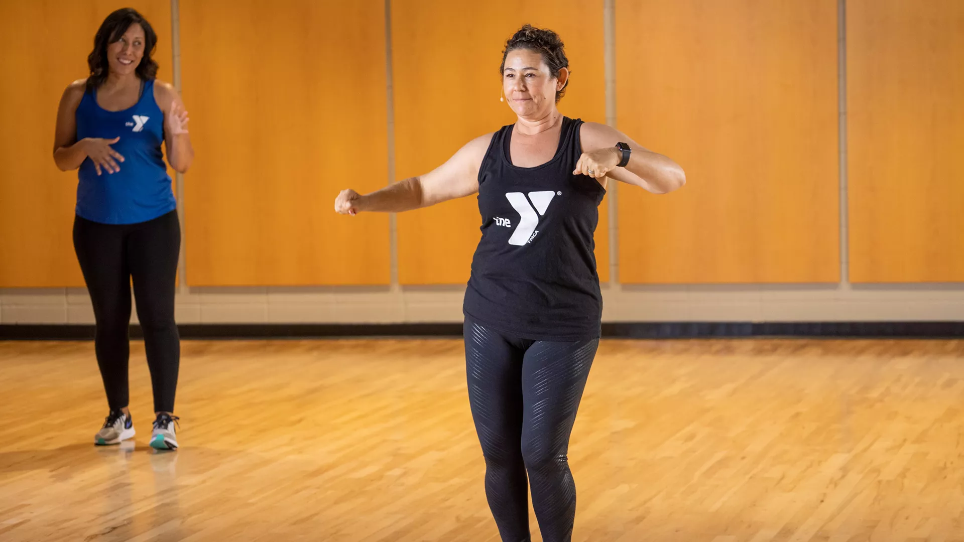 Women leading a YMCA360 dance class