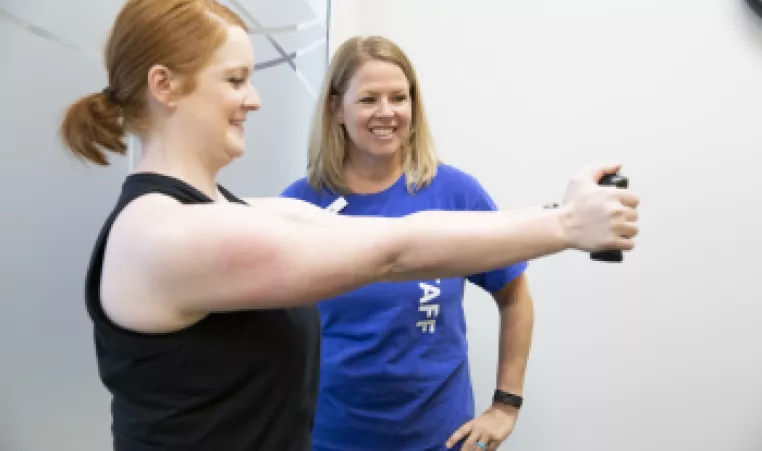 Woman works out with personal trainer