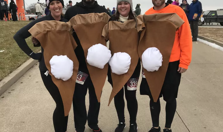 Four Turkey Trot participants dressed as pumpkin pie