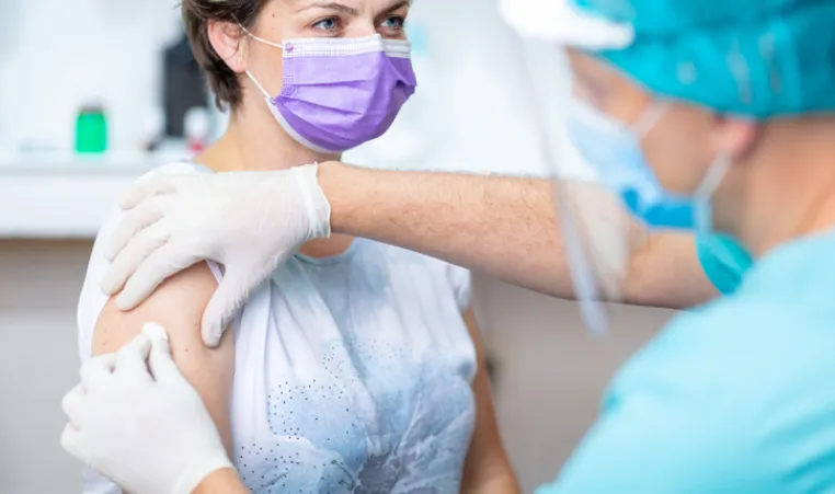 Woman in mask getting prepared for flu shot