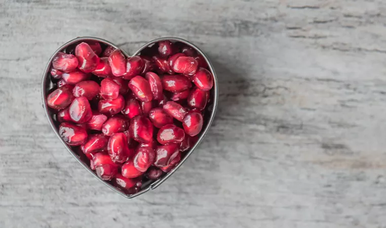 Photo of pomegranate seeds in the shape of heart