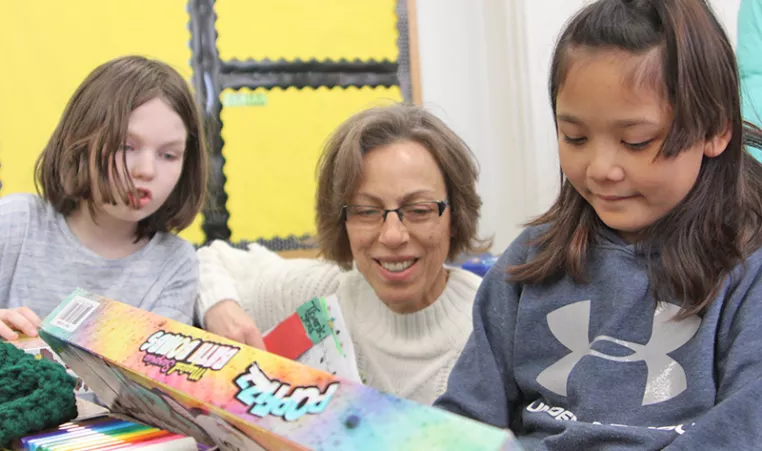 Photo of Michelle passing out gifts during our annual Giving Tree