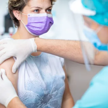 Woman in mask getting prepared for flu shot