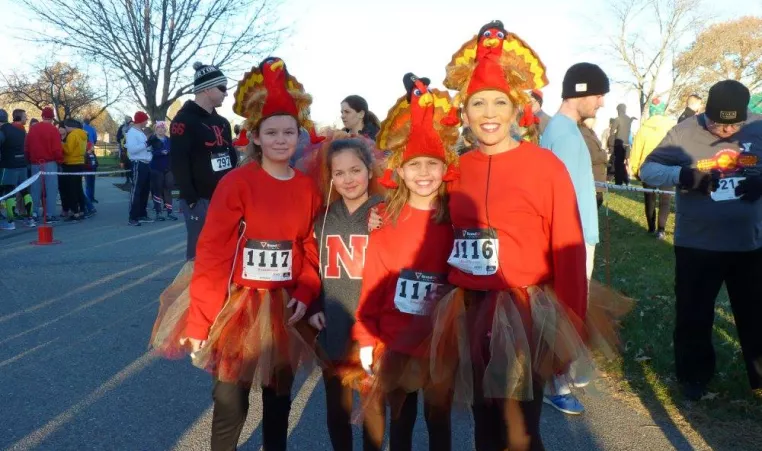 Turkey Trot runners pose in festive costumes